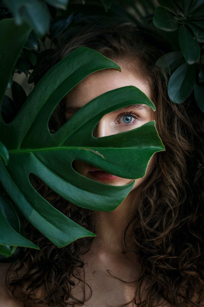 photo of woman covered with leaves 1834391